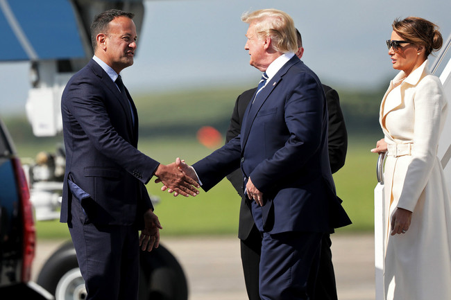 A handout picture released by the Irish government shows US President Donald Trump (C) being greeted by Irish Prime Minister Leo Varadkar (L) upon disembarking Air Force One upon arrival at Shannon Airport in Shannon, County Clare, Ireland on June 5, 2019 after attending an event to commemorate the 75th anniversary of the D-Day landings wrapping up a UK State Visit. US President Donald Trump and Queen Elizabeth II joined 300 veterans in paying tribute to their fallen comrades at a poignant ceremony on Wednesday marking the 75th anniversary of D-Day. Wrapping up a three-day State Visit to the UK Trump flew to Ireland where he is expected to hold a meeting with prime minister Leo Varadkar and visit his golf course near the village of Doonbeg. [Photo: AFP / IRISH GOVERNMENT]