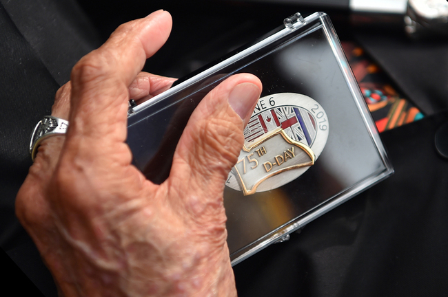 WWII US Native American veteran Charles Shay holds a 75th D-Day anniversary commemorative medal he received during a ceremony on Omaha Beach in Saint-Laurent-sur-Mer, western France on June 5, 2019, in homage to Native American who took part in the D-Day landings of World War II. [Photo: AFP/Loic Venance]