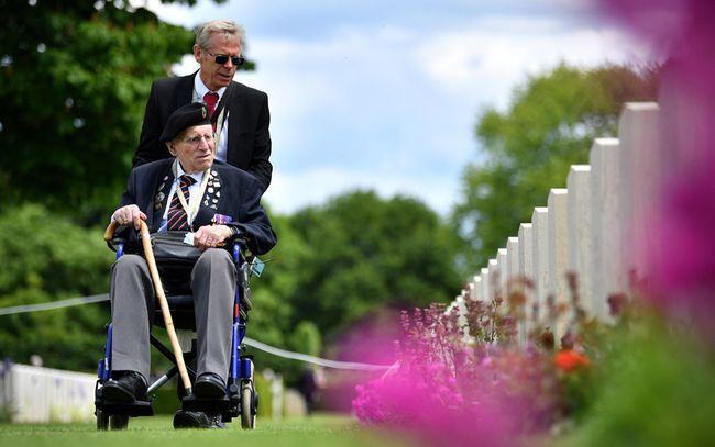 British army veteran Cedric Wasser looks at the graves of fallen soldiers during a Service of Remembrance at the Commonwealth War Graves Cemetery in Bayeux, Normandy, northwestern France, on June 6, 2019 as part of D-Day commemorations marking the 75th anniversary of the World War II Allied landings in Normandy. [Photo: AFP/Ben Stansall]