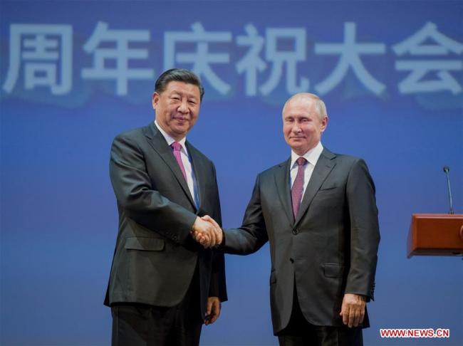 Chinese President Xi Jinping (L) and his Russian counterpart Vladimir Putin attend a gathering marking the 70th anniversary of the establishment of the China-Russia diplomatic relations at the Bolshoi Theater of Russia in Moscow June 5, 2019. [Photo: Xinhua]