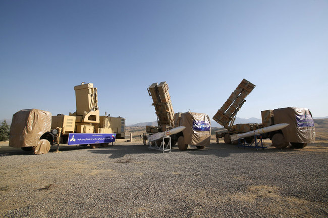 A handout picture made available by the Iranian Defence Ministry shows, the new surface-to-air missile batteries 'Khordad 15' next to Sayad missiles (white ones), during an inauguration ceremony at an undisclosed location in Iran. Media reported that the 'Khordad 15' has double power compared with previous one. [Photo: IC]<br/>