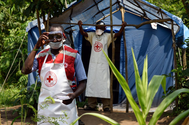 Health workers stand at a non-gazetted crossing point in the Mirami village, near the Mpondwe border check point between Uganda and the Democratic Republic of Congo on June 14, 2019. [Photo: AFP]