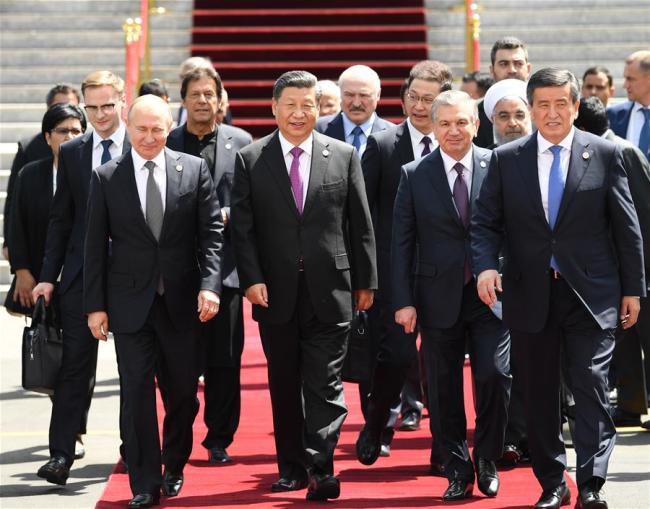 Chinese President Xi Jinping (2nd L, front) and other leaders of the Shanghai Cooperation Organization (SCO) member countries and observer states, as well as representatives of regional and international bodies, head for group photos during the 19th meeting of the Council of Heads of State of the SCO in Bishkek, Kyrgyzstan, June 14, 2019. [Photo: Xinhua/Yin Bogu]