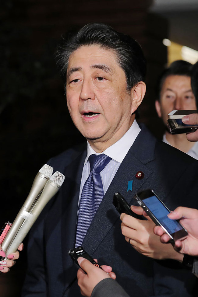 Japan's Prime Minister Shinzo Abe speaks to journalists following a strong 6.8-magnitude earthquake on the northwest of Japan, at his official residence in Tokyo on early June 19, 2019. [Photo: JIJI PRESS / AFP]