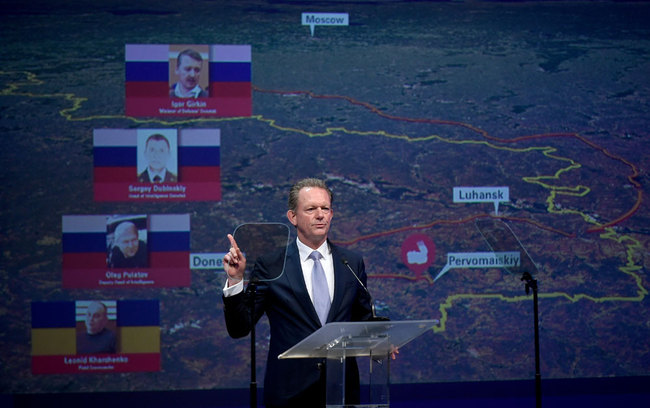 Chief Prosecutor with the National Prosecutor's Office of the Netherlands Fred Westerbeke, gestures next to the pictures of former FSB colonel Igor Girkin (from top to bottom), Sergei Dubinsky employed by Russia's GRU military intelligence agency, Oleg Pulatov former soldier of the Spetznaz GRU and Ukrainian Leonid Kharchenko, on June 19, 2019 in Nieuwegein during a press conference of the JIT on the ongoing investigation of the Malaysia Airlines MH17 crash in 2014. The Dutch-led probe said it was going to prosecute Russian nationals Igor Girkin, Sergey Dubinsky and Oleg Pulatov as well as Ukrainian Leonid Kharchenko over the downing of the Malaysia Airlines plane. [Photo: AFP/John Thys]