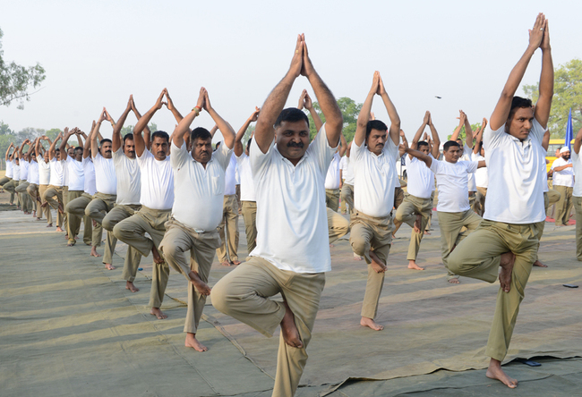 Indian Border Security Force (BSF) personnel take part in a yoga session on International Yoga Day at BSF headquarters in Khasa on the outskirts of Amritsar on June 21, 2019. [Photo: AFP/Narinder Nanu]