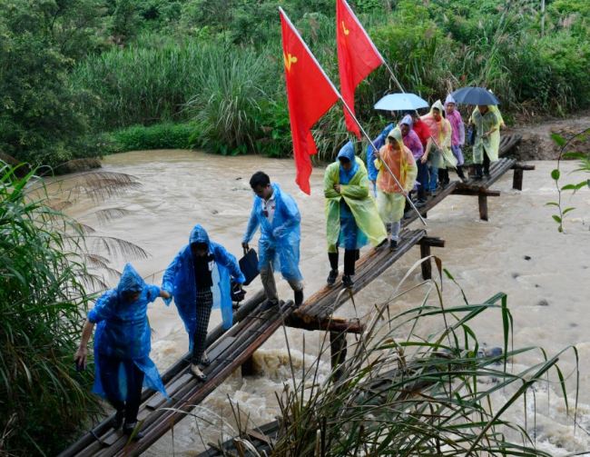 A group of people retracing the route of the Long March visited the river in Yudu County, Jiangxi Province on June 13, 2019. [Photo: IC]