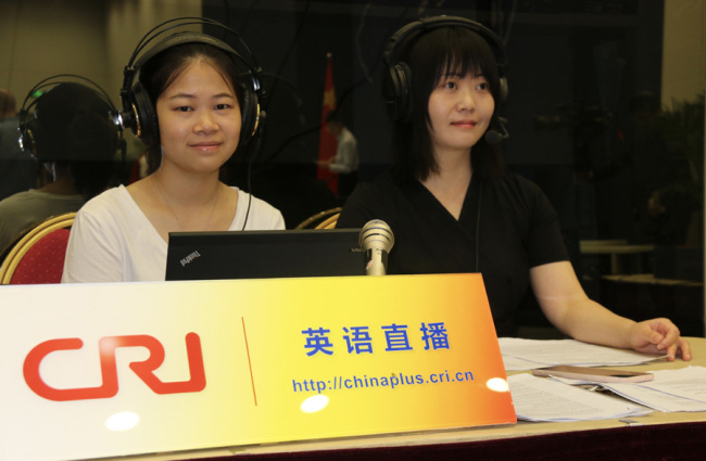 China Plus host Zhou Fang (right) at the news conference hall at China's Ministry of Foreign Affairs [Photo: China Plus]