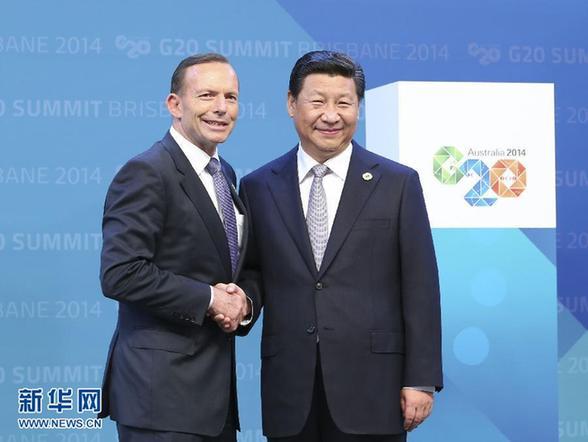 Chinese President Xi Jinping shakes hands with Australian Prime Minister Tony Abbott while attending the G20 summit in Brisbane, on November 15, 2014. [Photo: Xinhua]