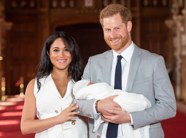 In this file photo taken on May 08, 2019 Britain's Prince Harry, Duke of Sussex (R), and his wife Meghan, Duchess of Sussex, pose for a photo with their newborn baby son, Archie Harrison Mountbatten-Windsor, in St George's Hall at Windsor Castle, England, UK. [File Photo: AFP/Pool/Dominic Lipinski]