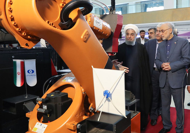 A handout picture made available by the Iranian presidential office shows, Iranian President Hassan Rouhani (L) listening to head of Iran's nuclear technology organisation Ali Akbar Salehi (R) during the "nuclear technology day" in Tehran on April 9, 2019. [File photo: Iranian Presidency / AFP]