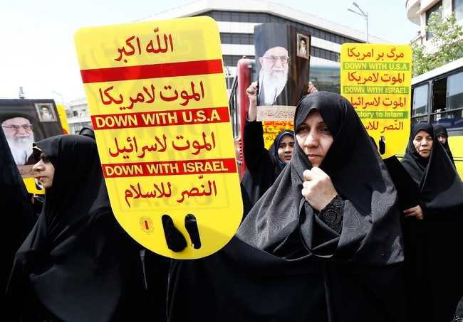 Iranian demonstrators raise placards and portraits of Iran's Supreme Leader Ayatollah Ali Khamenei as they chant anti-US slogans during a rally in the capital Tehran, on May 10 2019. [Photo: AFP]