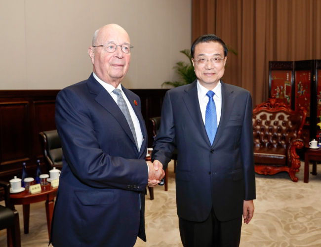 Premier Li Keqiang meets with Executive Chairman of the World Economic Forum Klaus Schwab in Dalian, northeast China's Liaoning province on Monday, July 1, 2019.[Photo: gov.cn]