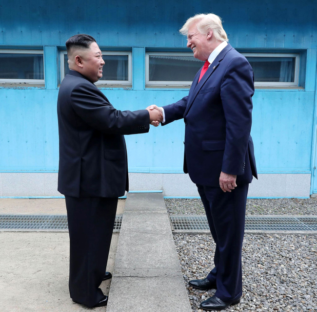 DPRK's leader Kim Jong Un (L) shakes hands with U.S. President Donald Trump at the Military Demarcation Line in the Joint Security Area (JSA) of Panmunjom in the demilitarized zone (DMZ) on June 30, 2019. [Photo: VCG/KCNA]