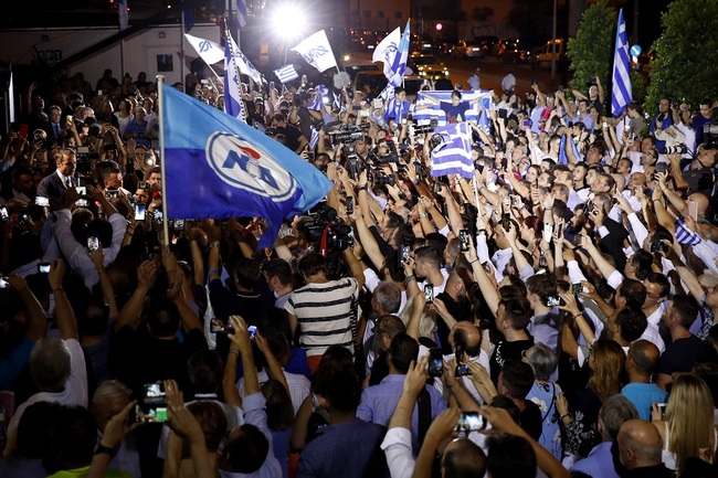 Greek opposition New Democracy conservative party leader Kyriakos Mitsotakis, left, talks to his supporters after win the parliamentary elections at the New Democracy headquarters in Athens, on Sunday, July 7, 2019. [Photo: IC]