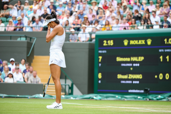 Zhang Shuai of China reacts during the women's singles quarter-final match of the Wimbledon Lawn Tennis Championships against Simona Halep of Romania at the All England Lawn Tennis and Croquet Club in London, England on July 9, 2019. [Photo: IC]