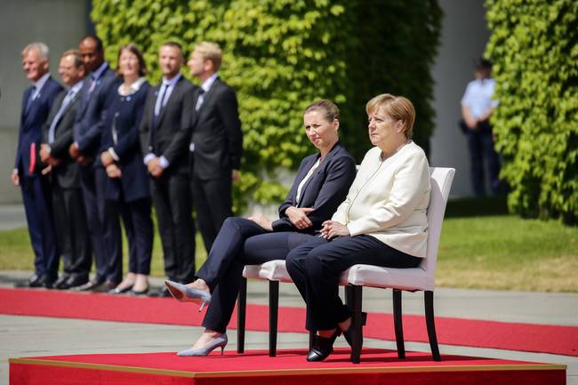 German Chancellor Angela Merkel and the visiting Danish prime minister sit through their countries' national anthems at a ceremony in Berlin on July 11, 2019. [Photo: IC]