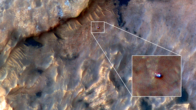 NASA's Curiosity Mars rover can be seen in this image taken from space on May 31, 2019, by the HiRISE camera aboard the Mars Reconnaissance Orbiter. In the image, Curiosity appears as a bluish speck. [Photo: nasa.gov/JPL-Caltech]