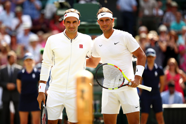 Roger Federer of Switzerland and Rafael Nadal of Spain pose for a picture at the net prior to their Men's Singles semi-final match during Day eleven of The Championships - Wimbledon 2019 at All England Lawn Tennis and Croquet Club on July 12, 2019 in London, England. [Photo: VCG]