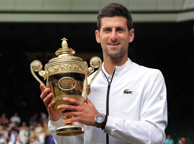 Novak Djokovic of Serbia celebrates with the winner's trophy after beating Roger Federer of Switzerland (not seen) at the Wimbledon Tennis Championships 2019 held on Day 13 held at the All England Lawn Tennis and Croquet Club on July 14, 2019 in London, United Kingdom. [Photo: IC]