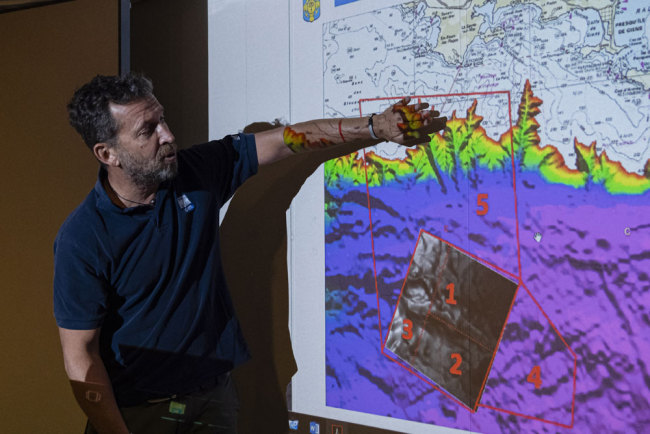 A handout made available by the French Navy and the Defense Ministry on July 22, 2019 shows a staff member during a work meeting with the Defense Ministry and the 'Naval Hydrographic and Oceanographic Service' (SHOM), off the coast of Toulon, France, July 18, 2019. [Photo: EPA/ Marine Nationale Handout via IC/Sebastien Chenal]