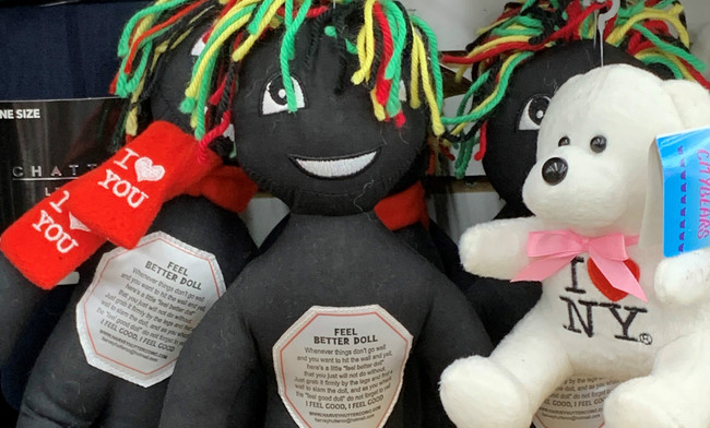 This undated photo provided by New Jersey state Assemblywoman Angela McKnight shows three "Feel Better Dolls" sharing the shelf with a stuffed animal bearing an "I Love New York" message at a One Dollar Zone store in Bayonne, N.J. The black rag "Feel Better" dolls that came with instructions to "find a wall" and slam the toy against it have been pulled from three stores after customers and the lawmaker said they were offensive. [Photo: AP/Angela McKnight]