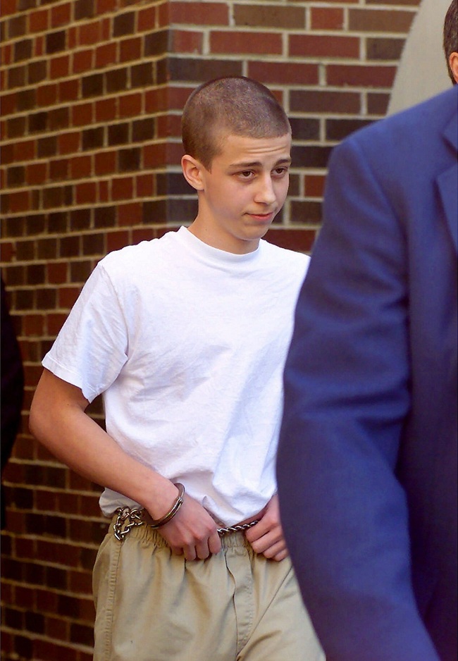 File Photo: Convicted Westside Middle School shooter Andrew Golden, 13, is escorted from a back door of the Craighead County Courthouse in Jonesboro, Ark, April 27, 2000. [Photo: AP/Rodney Freeman/The Jonesboro Sun]