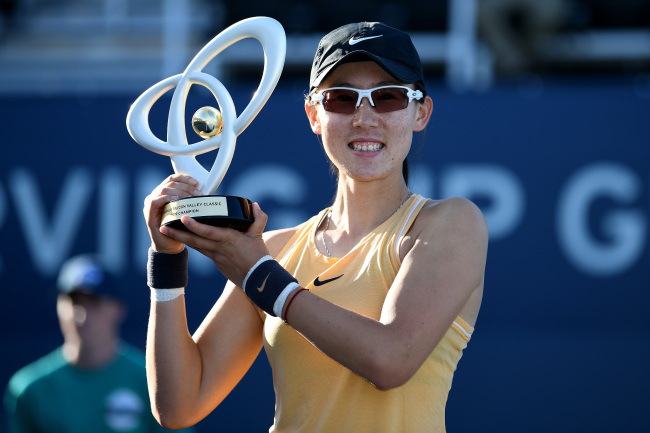 Saisai Zheng of China celebrates with the winner's trophy after defeating Aryna Sabalenka of Belarus in the singles final of the Mubadala Silicon Valley Classic at the San José State University Tennis Center on August 4, 2019 in San Jose, California. [Photo: Getty Images via VCG/Robert Reiners]