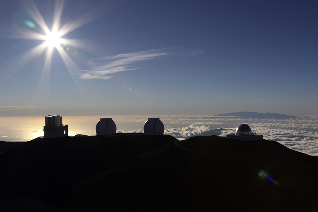 In this Sunday, July 14, 2019, file photo, the sun sets behind telescopes at the summit of Mauna Kea in Hawaii. [Photo: AP/Caleb Jones]