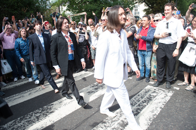 Beatles Lookalike band 'Fab Gear' pose on the famous Abbey Road crossing outside Abbey Road Studios, London, England on Thursday August 8, 2019 to mark the 50th Anniversary of the day the photograph was taken for the album cover. [Photo: IC]