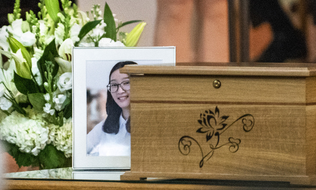 This photo shows a box containing some of Yingying Zhang's possessions, and a photo of her during a memorial service, Friday, Aug. 9, 2019 at the First Baptist Church in Savoy, Ill. The family of Yingying Zhang, a Chinese scholar whose body was never recovered after her 2017 slaying gathered at a memorial service that included only her photograph and their own memories of her life. [Photo: Robin Scholz/The News-Gazette via AP]