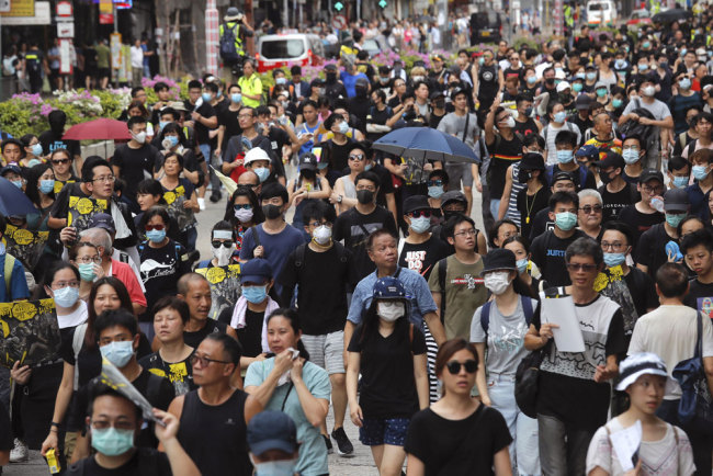 Protesters block a street in Hong Kong on Sunday, August 11, 2019. [Photo: AP/Kin Cheung]