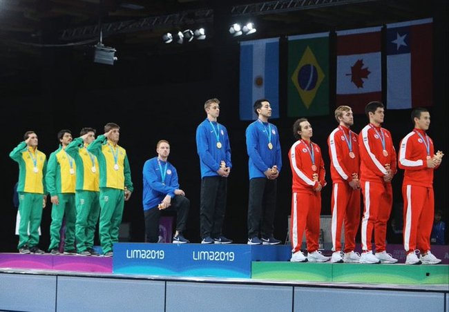 Race Imboden takes a knee on the podium as the U.S. national anthem plays at the award ceremony for men's foil team event at the Pan American Games in Lima, Peru on August 9, 2019. [Photo from Race Imboden's Twitter account @Race_Imboden<br>]