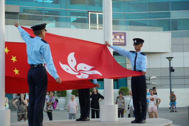 Flags of China and Hong Kong Special Administrative Region of the People's Republic of China are seen during a flag-raising ceremony in Hong Kong. [File photo: IC]