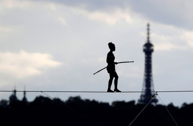 Tightrope walker Tatiana-Mosio Bongonga walks on a rope above the Prague Castle to open an international circus and theatre festival in Prague, Czech Republic, August 14, 2019. [Photo: Reuters via VCG/David W Cerny]