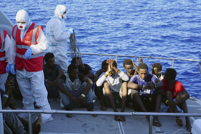 Migrants are evacuated by Italian Coast guards from the Open Arms Spanish humanitarian boat at the coasts of the Sicilian island of Lampedusa, southern Italy, Saturday, Aug. 17, 2019. [Photo: AP]