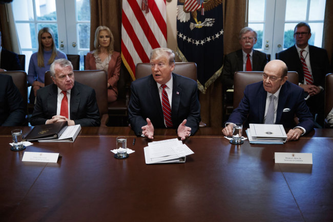 U.S. Deputy Secretary of State John Sullivan, left, and Commerce Secretary Wilbur Ross, right, listen as President Donald Trump speaks during a cabinet meeting at the White House, Tuesday, Feb. 12, 2019, in Washington. [File photo: AP/Evan Vucci]