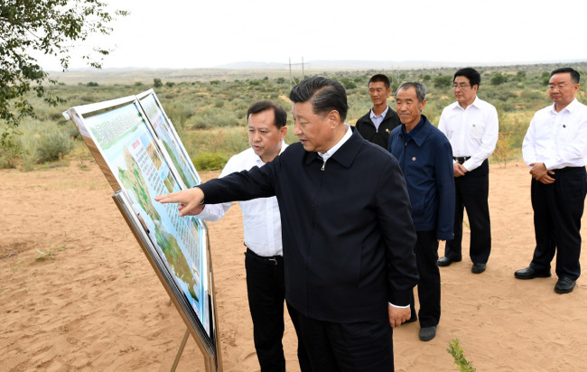 Xi Jinping, general secretary of the Communist Party of China Central Committee, inspects an afforestation program in a desert area of Gansu Province, August 21, 2019. [Photo: Xinhua]