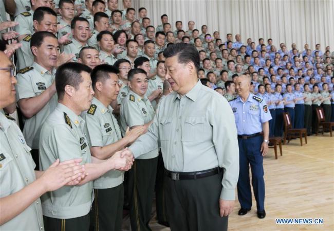 Chinese President Xi Jinping, also general secretary of the Communist Party of China Central Committee and chairman of the Central Military Commission, shakes hands with military officials when inspecting an air force base in Gansu Province on August 22, 2019. [Photo: Xinhua/Li Gang]