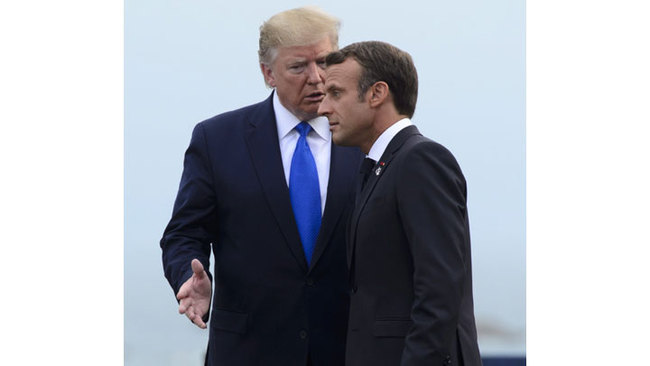 U.S. President Donald Trump, left, is greeted by the President of France Emmanuel Macron as he arrives to the G7 Summit in Biarritz, France, Saturday, Aug. 24, 2019. [Photo: Sean Kilpatrick/The Canadian Press via AP]