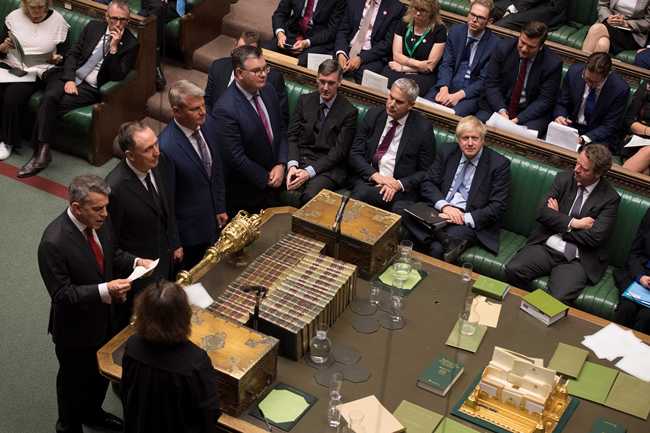 A handout photograph shows Britain's Prime Minister Boris Johnson (CR) listening as the tellers read out the result of the vote on the EU (Withdrawal) (No.6) Bill in the House of Commons in London on September 4, 2019. [Photo: JESSICA TAYLOR / UK PARLIAMENT / AFP]