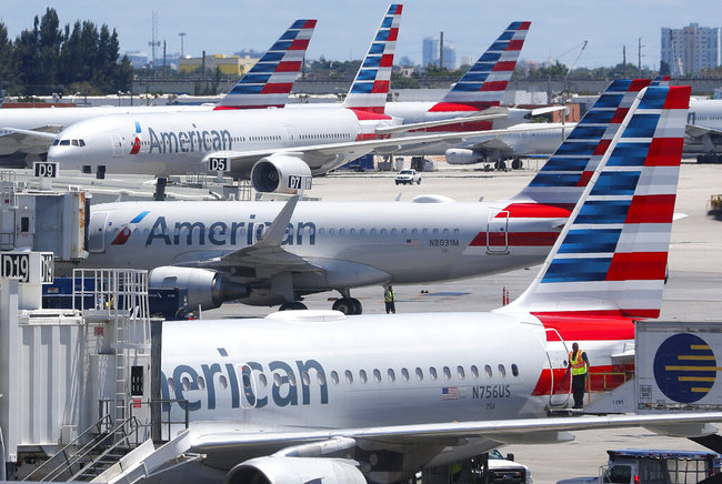 In this April 24, 2019, photo, American Airlines aircraft are shown parked at their gates at Miami International Airport in Miami. An American Airlines mechanic is accused of sabotaging a flight from Miami International Airport to Nassau in the Bahamas, over stalled union contract negotiations. Citing a criminal complaint affidavit filed in federal court, The Miami Herald reports Abdul-Majeed Marouf Ahmed Alani was arrested Thursday, Sept. 5, 2019, on the sabotage charge and is accused of disabling the flight's navigation system.[File Photo: AP] 