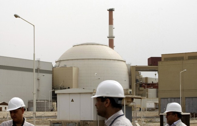 Iranian technicians walk outside the building housing the reactor of Bushehr nuclear power plant at the Iranian port town of Bushehr on February 25, 2009. [File photo: AFP/ Behrouz MEHRI] 