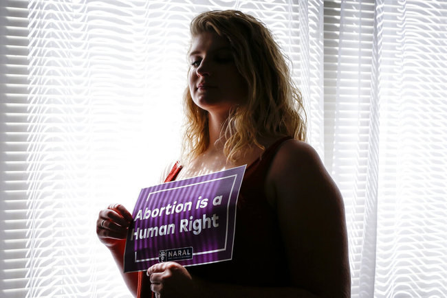 In this Aug. 5, 2019, photo, Beth Vial, who didn’t learn she was pregnant until 26 weeks after chronic medical conditions masked her symptoms, poses for a portrait at her home in Portland, Ore. [Photo: AP]