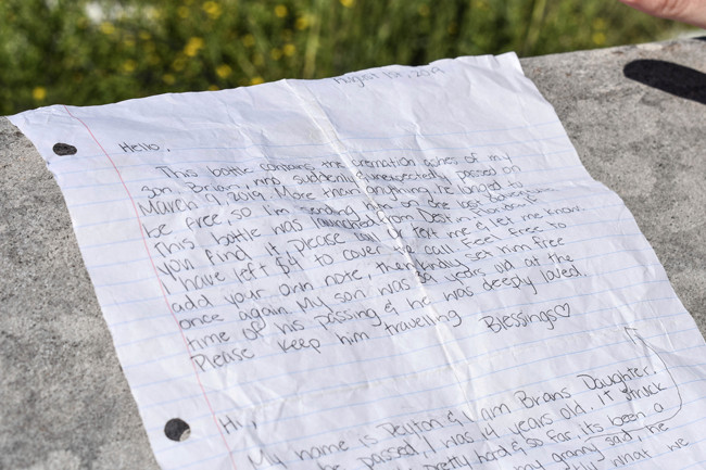 In this undated photo provided by the Walton County Sheriff's Office, a note written by the mother and daughter accompanied the ashes of Brian Mullins found in a bottle that washed ashore last week near Miramar Beach, Fla. A bottle containing the ashes of a Texas man along with some handwritten notes from loved ones has been returned to the Gulf of Mexico, resuming its ocean journey after it washed up on a Florida Panhandle beach. [Photo: AP/Corey Dobridnia/Walton County Sheriff’s Office]