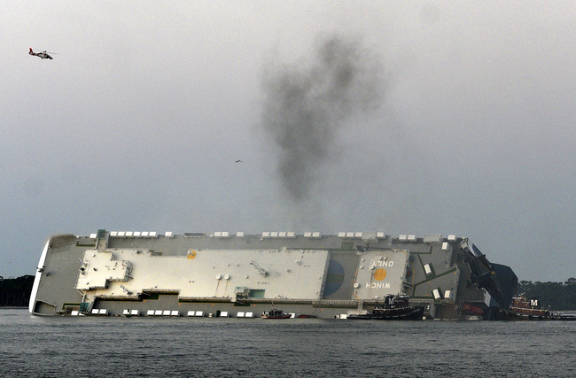 Smoke rises from a cargo ship that capsized in the St. Simons Island, Georgia sound Sunday, Sept. 8, 2019. [Photo: AP/Bobby Haven/The Brunswick News]