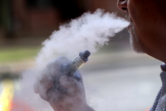 A man exhales while using an e-cigarette Wednesday, in Portland, Maine, August 28, 2019. [File Photo: AP via IC/Robert F. Bukaty]