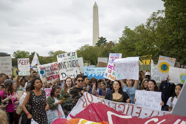 Teenagers and students take part in a climate protest outside the White House (background) in Washington on September 13, 2019. [Photo: AFP/Alastair Pike]