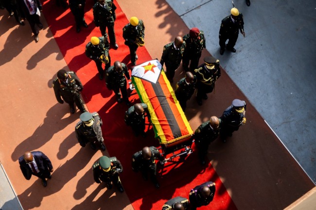 Relatives follow pallbearers carrying the casket as they leave the National Sports Stadium in Harare after attending a farewell ceremony on September 14, 2019. [Photo: AFP]