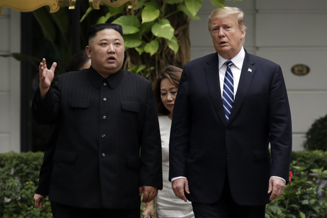 In this Feb. 28, 2019 file photo, Kim Jong Un, top leader of the Democratic People's Republic of Korea (DPRK), and U.S. President Donald Trump take a walk after their first meeting at the Sofitel Legend Metropole Hanoi hotel in Hanoi. [File Photo: AP via IC]